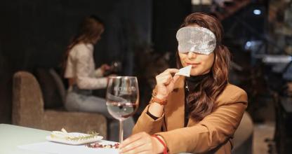 žena sediaca za stolom s obrúskom na hlave