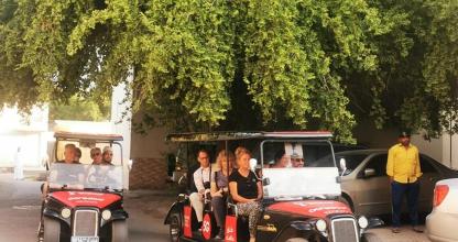 a group of people riding in an old car