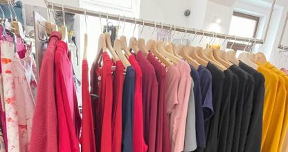 a bunch of clothes on a rack in a store