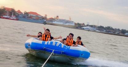 a group of people in a raft in the water