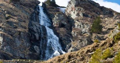 a waterfall on the side of a mountain