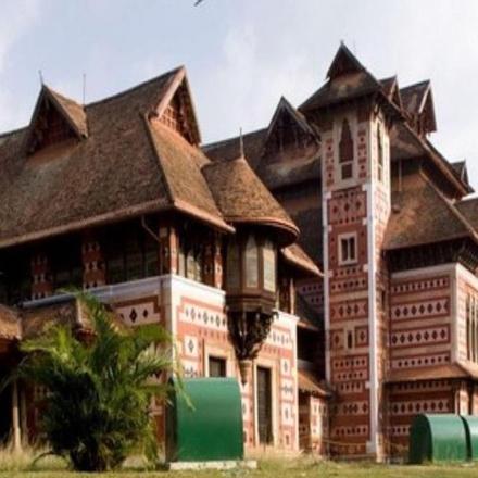 a large wooden house with a gambrel roof