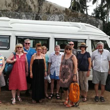 a group of people standing in front of a van