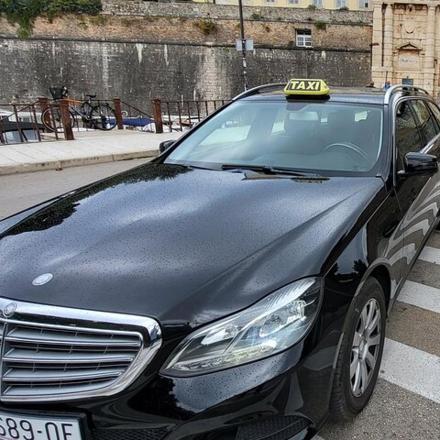 a black car parked on the side of a street