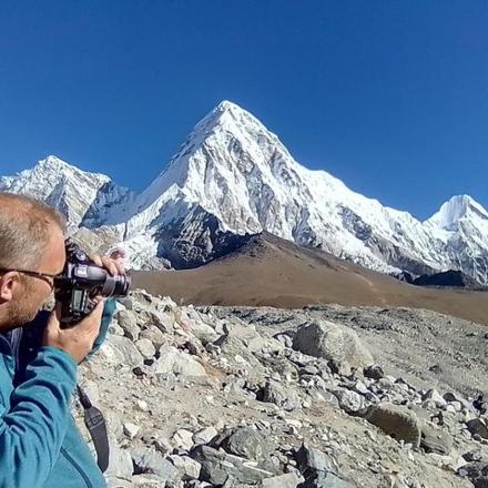 a man taking a picture of a mountain