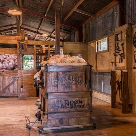 a large room with a wooden barn with a barrel