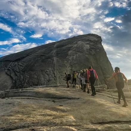 a group of people walking on top of a mountain