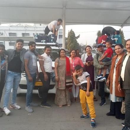 a group of people standing in front of a truck