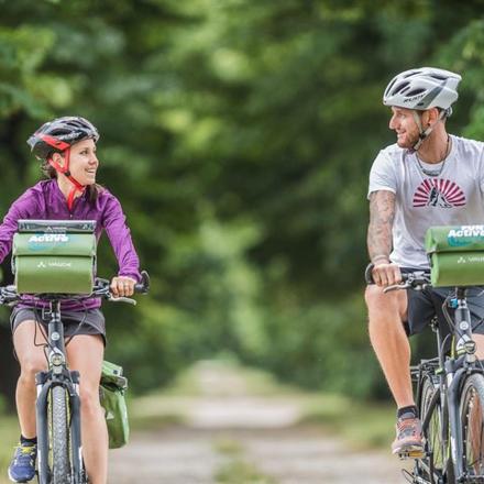 a man and a young girl riding bikes down a trail