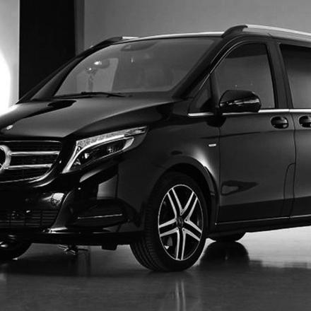 a black car is parked in a room