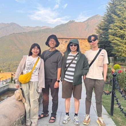 a group of people posing for a picture on a bridge