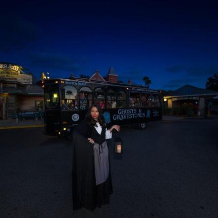 a woman is standing in front of a bus