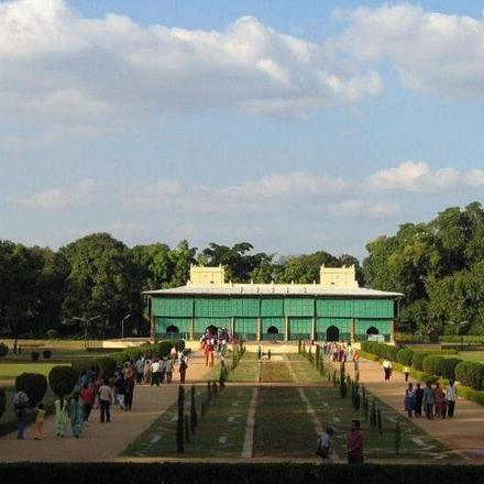 a group of people walking around a building in a park