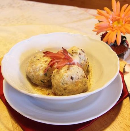 a bowl of meatballs on a plate with a fork