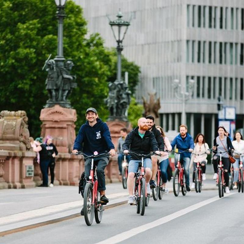 a group of people riding bikes down a street