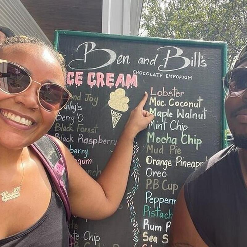 a man and a woman standing in front of a sign