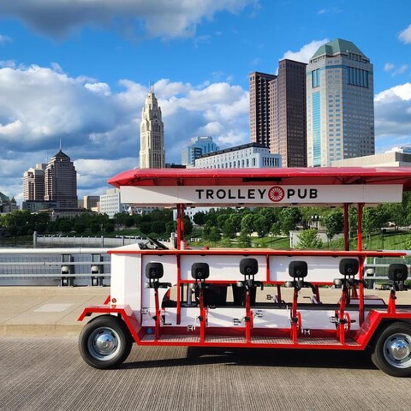 a red and white food cart with a red umbrella