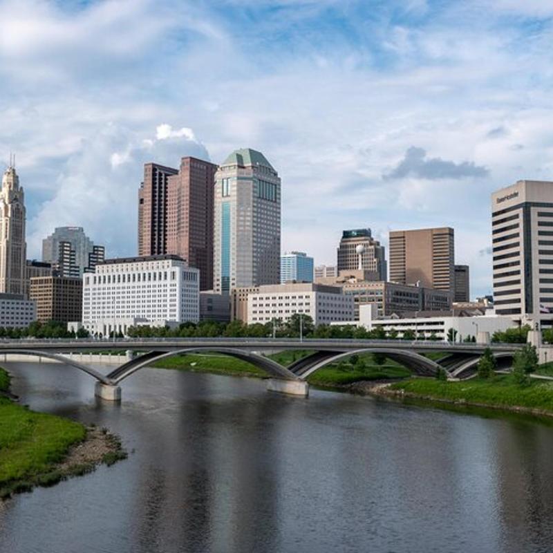 a bridge over a river in front of a city