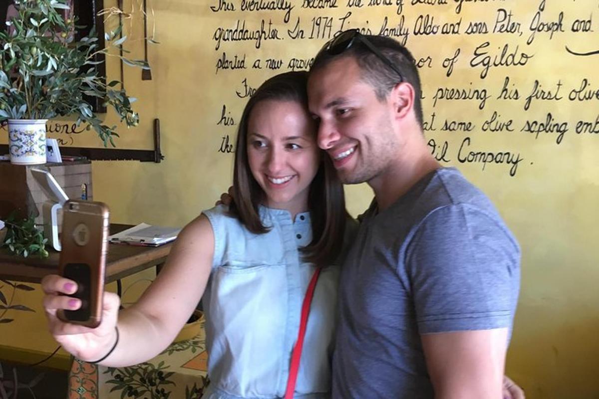 a man and a woman taking a picture with a cell phone