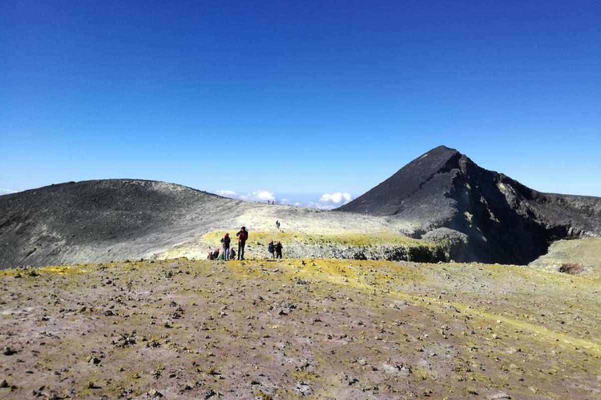 a group of people walking up a mountain