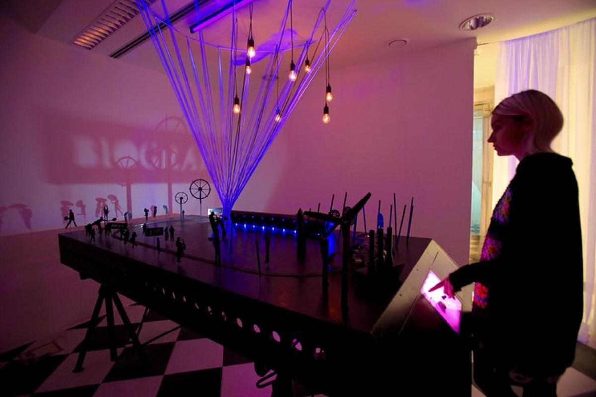 a woman standing in front of a piano in a room
