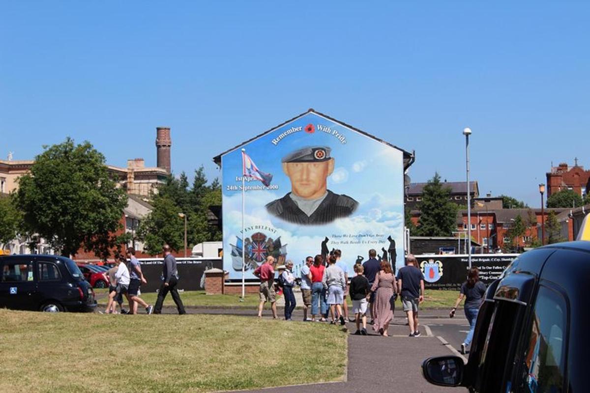 a group of people walking in front of a large billboard