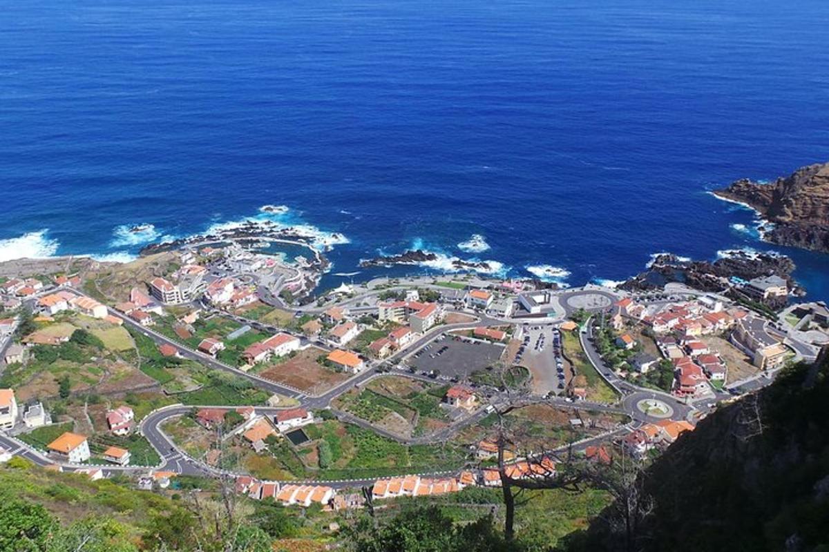an aerial view of a town next to the ocean