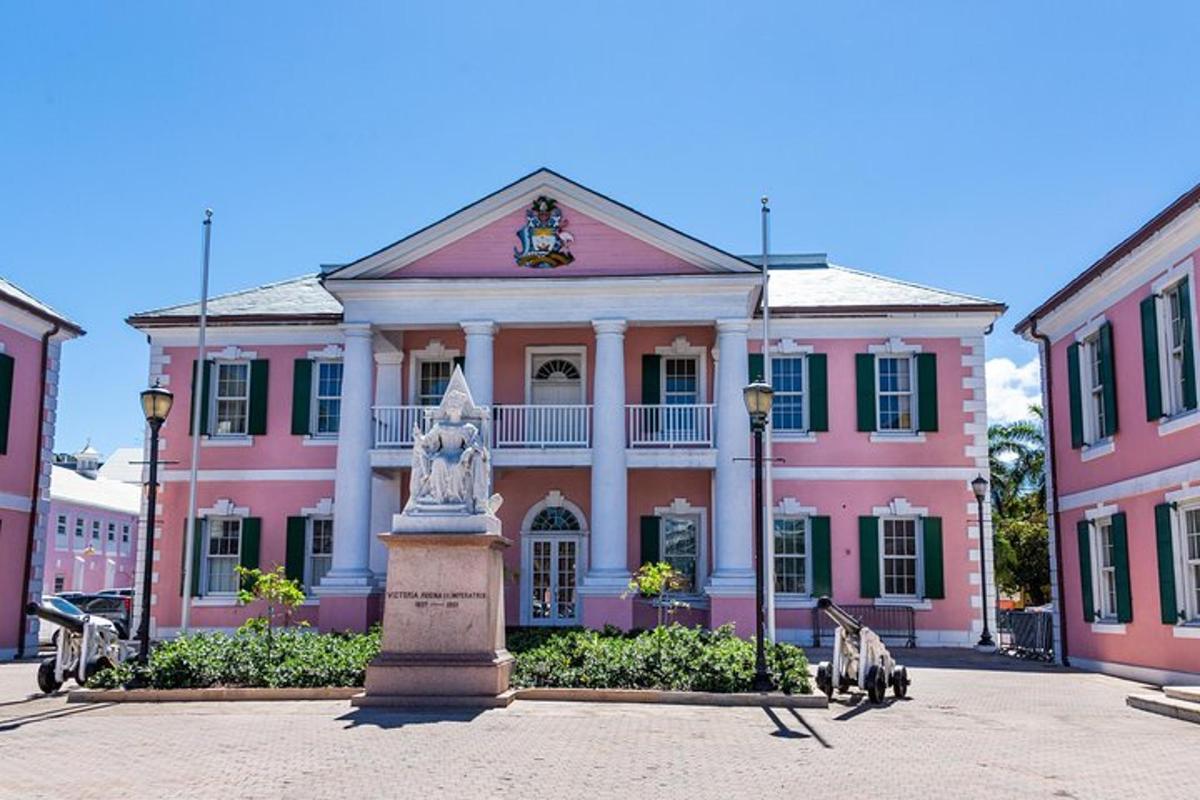 a pink building with a statue in front of it