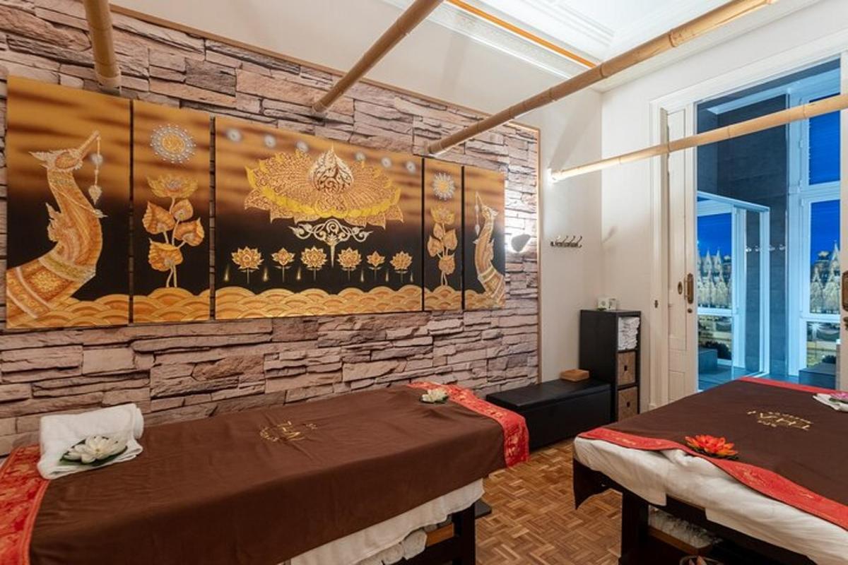 a room with two beds and a stone wall