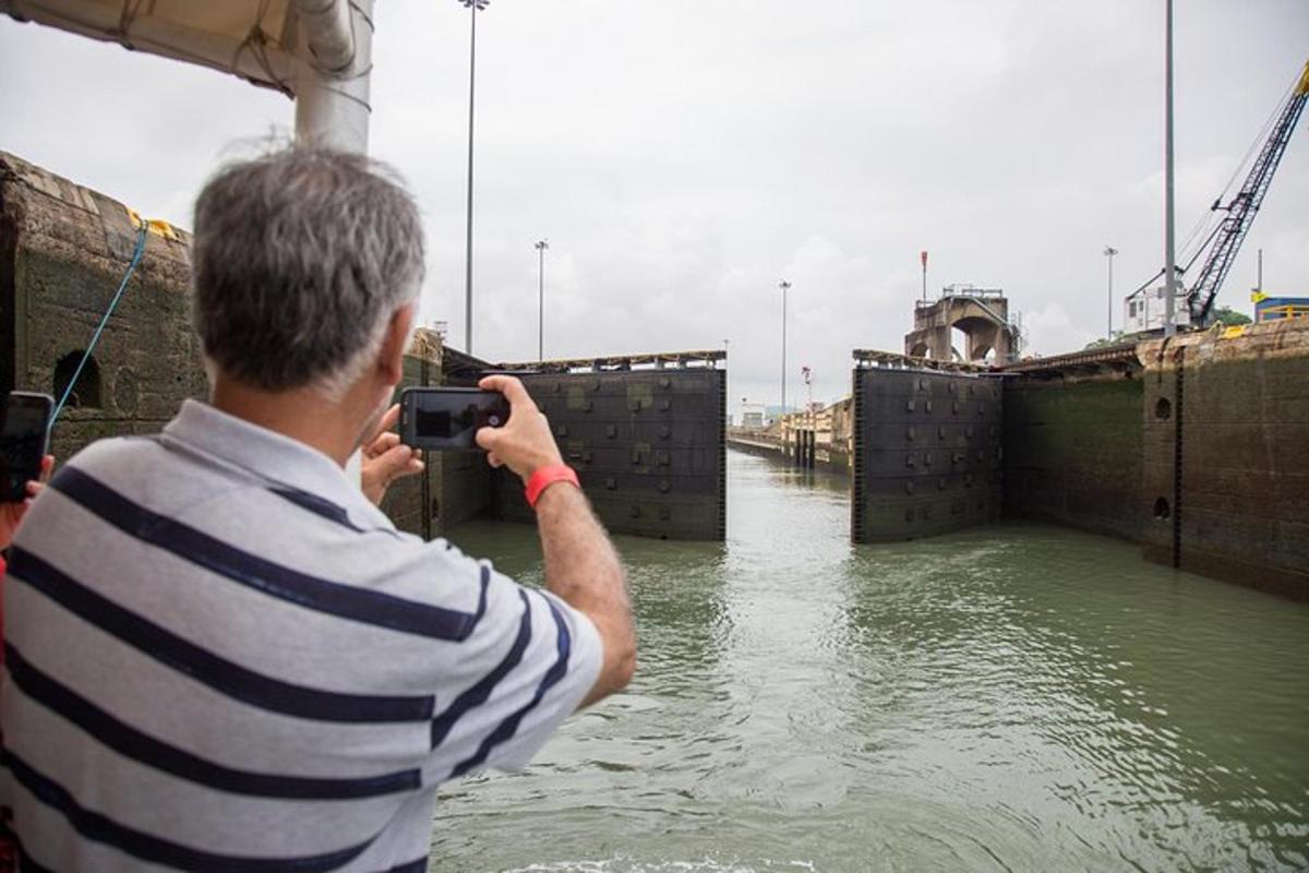 ein Mann, der mit einer Kamera ein Foto von einem Fluss macht