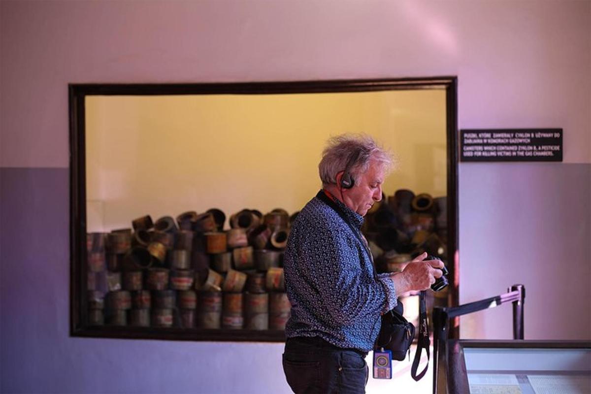 an older woman holding a camera in front of a mirror