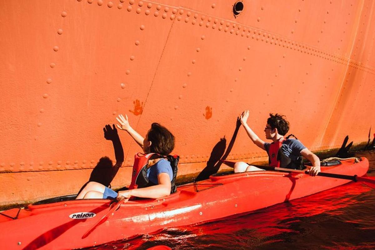 two people in a red kayak in the water