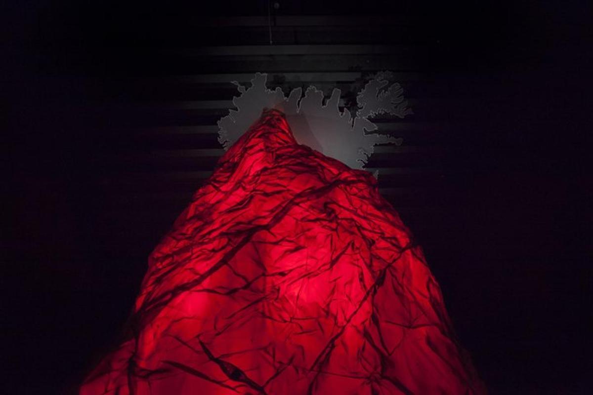 a red dress is hanging on a wall