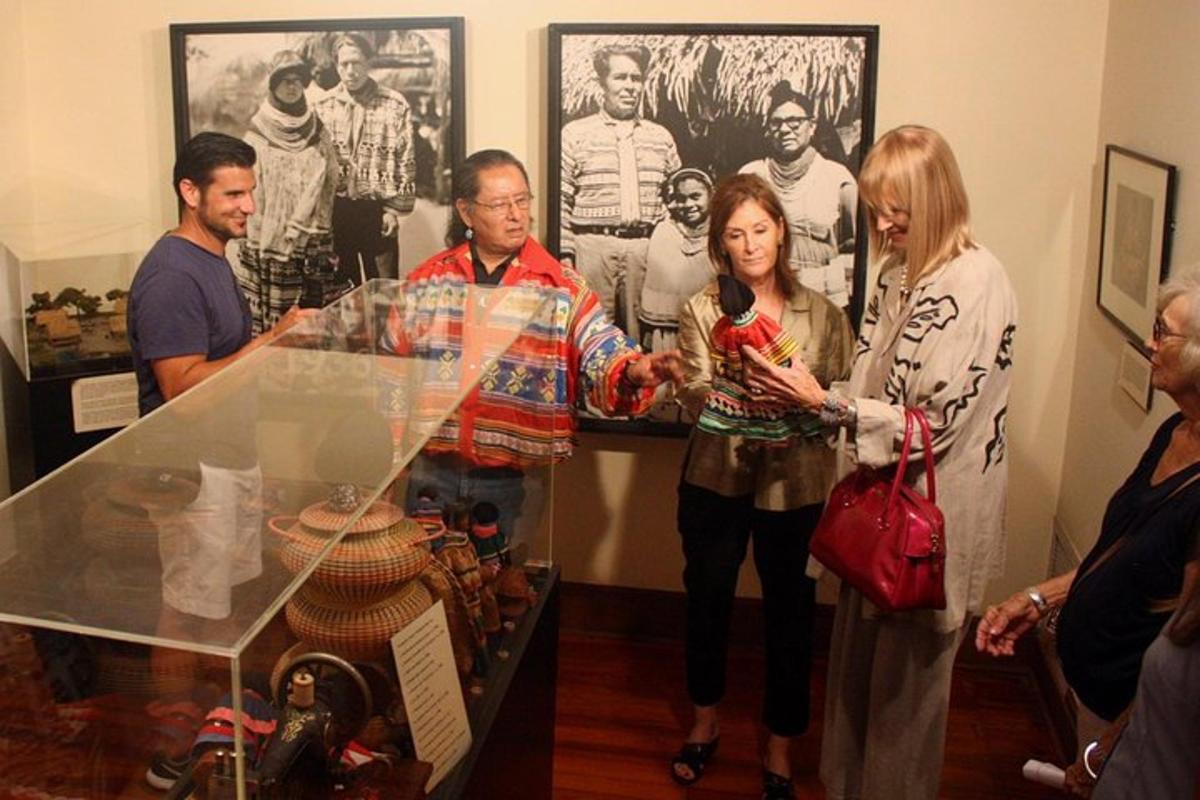 a group of people standing around a glass table