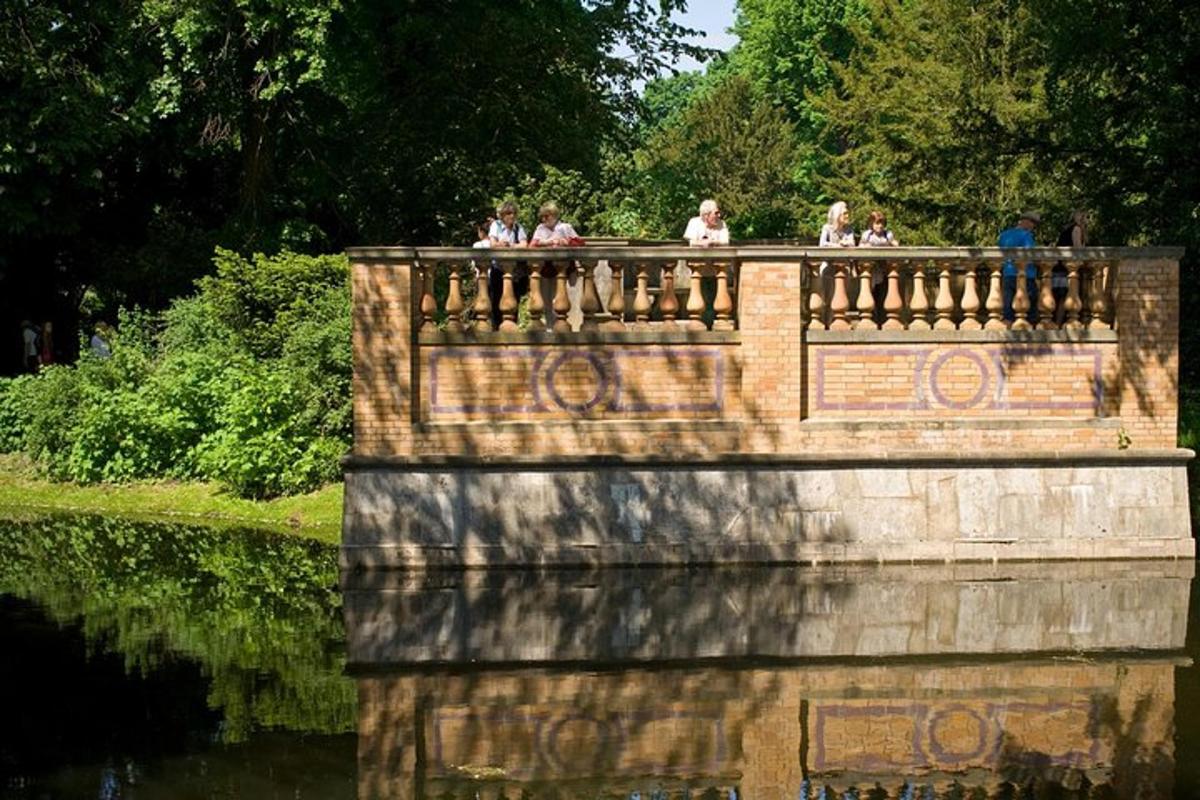 people standing on a bridge over a body of water