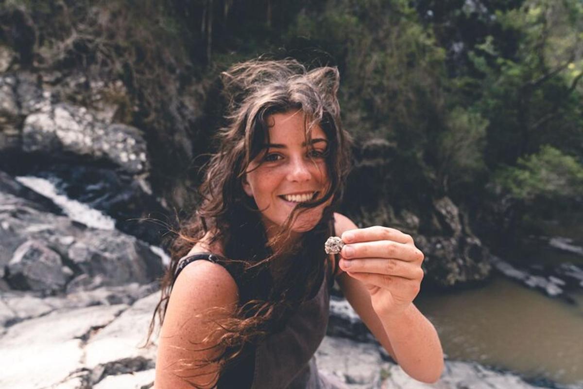 a woman holding a flower in her hand