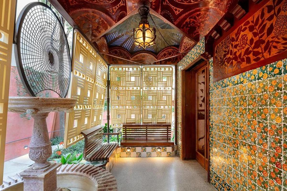 a room with a staircase and a wall covered in tiles