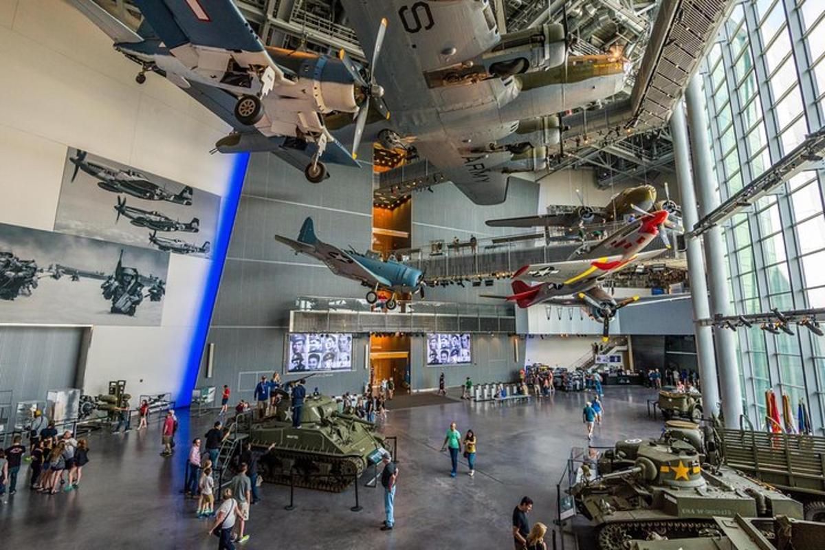 a museum with tanks and planes hanging from the ceiling