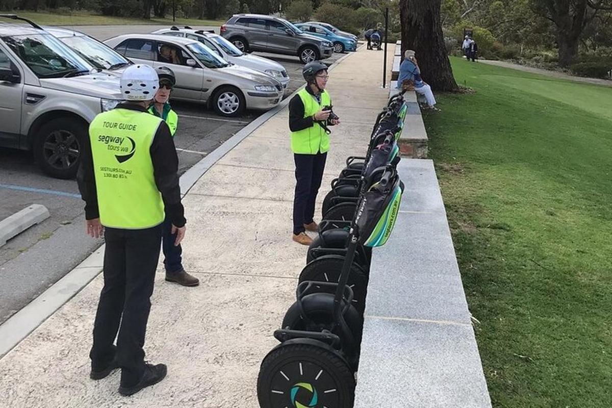 a group of people in yellow vests standing on a sidewalk