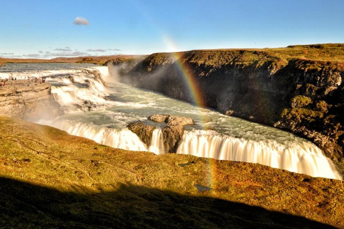 a waterfall with a rainbow on top of it