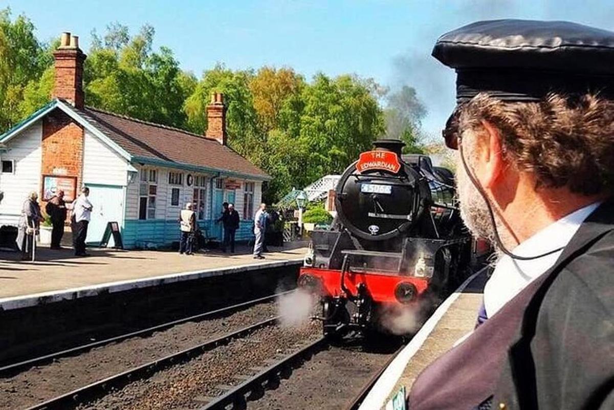 a steam train pulling into a train station
