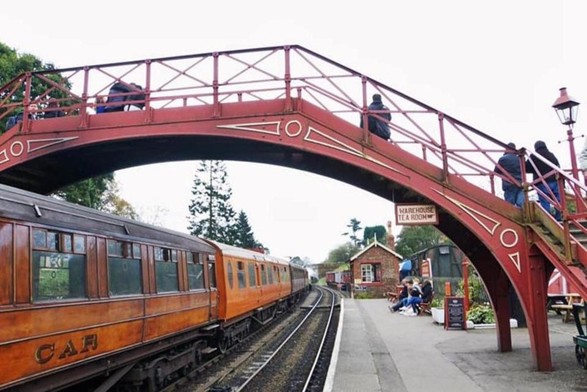 a red bridge with a train on the tracks