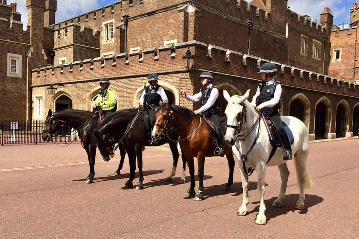 four police officers on horses in front of a castle