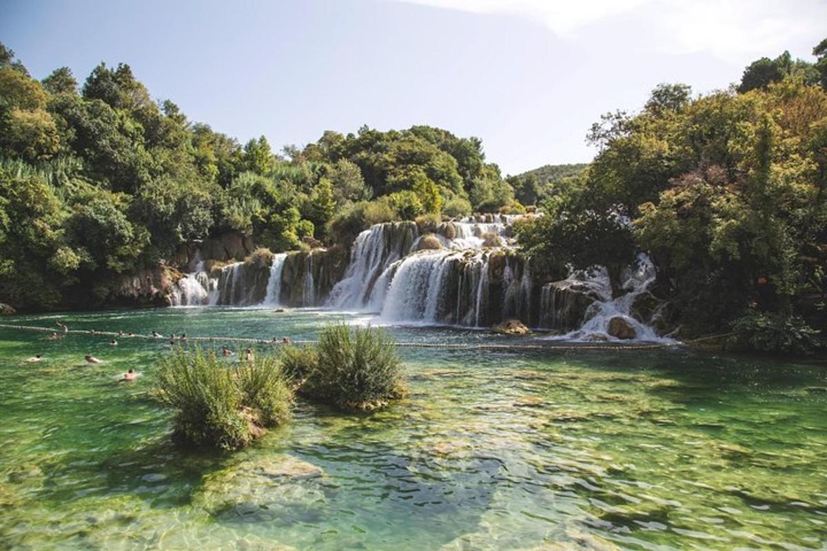 a waterfall in front of a pool of water
