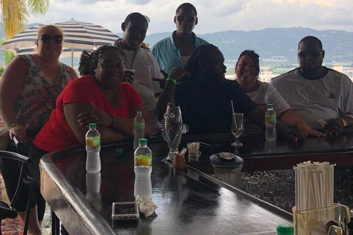 a group of people sitting around a table with drinks