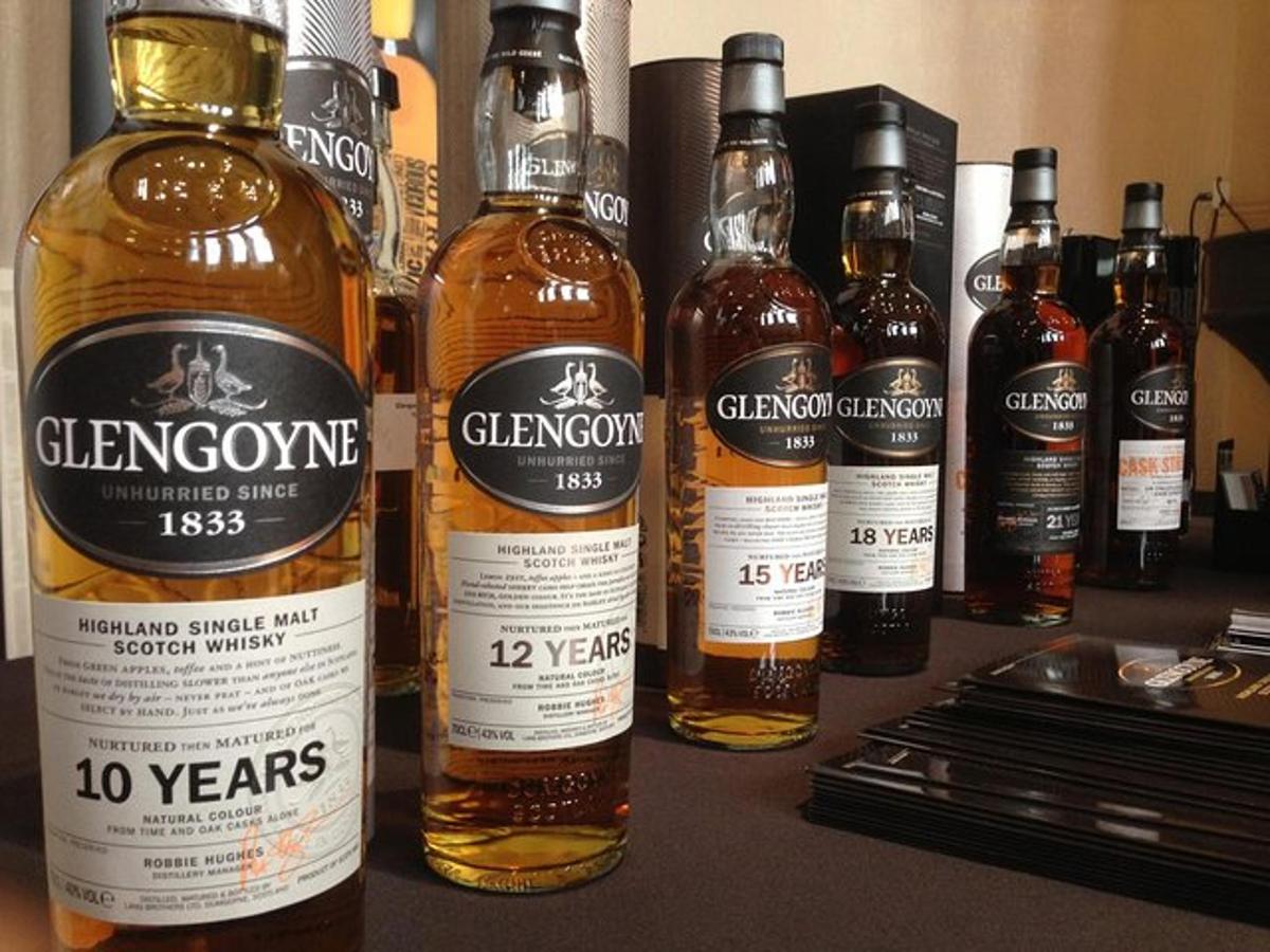 a group of bottles of whisky sitting on a table