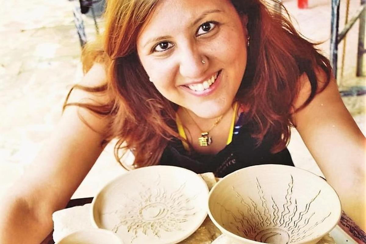 a woman sitting at a table with two bowls