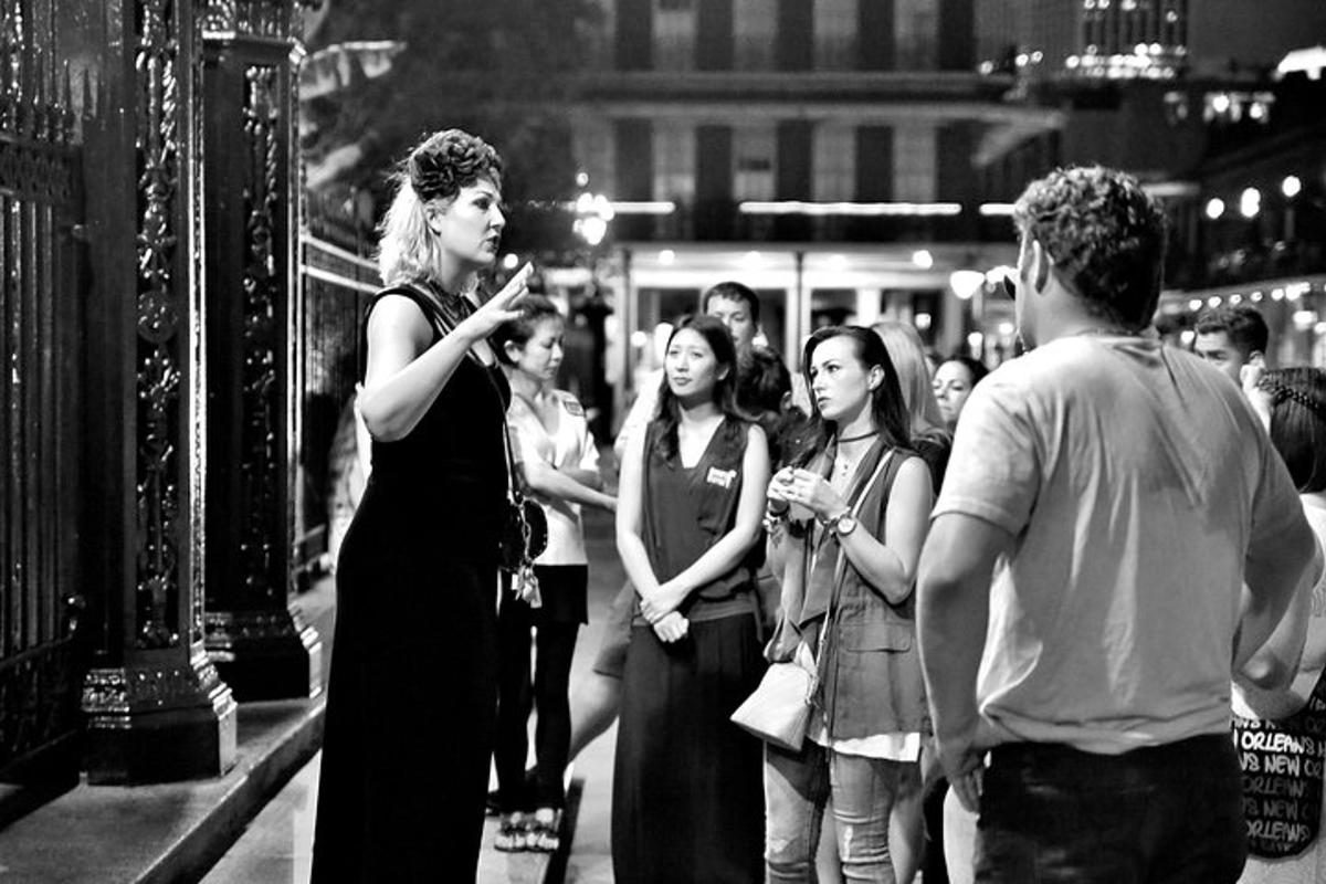 a woman standing on a street looking at her cell phone