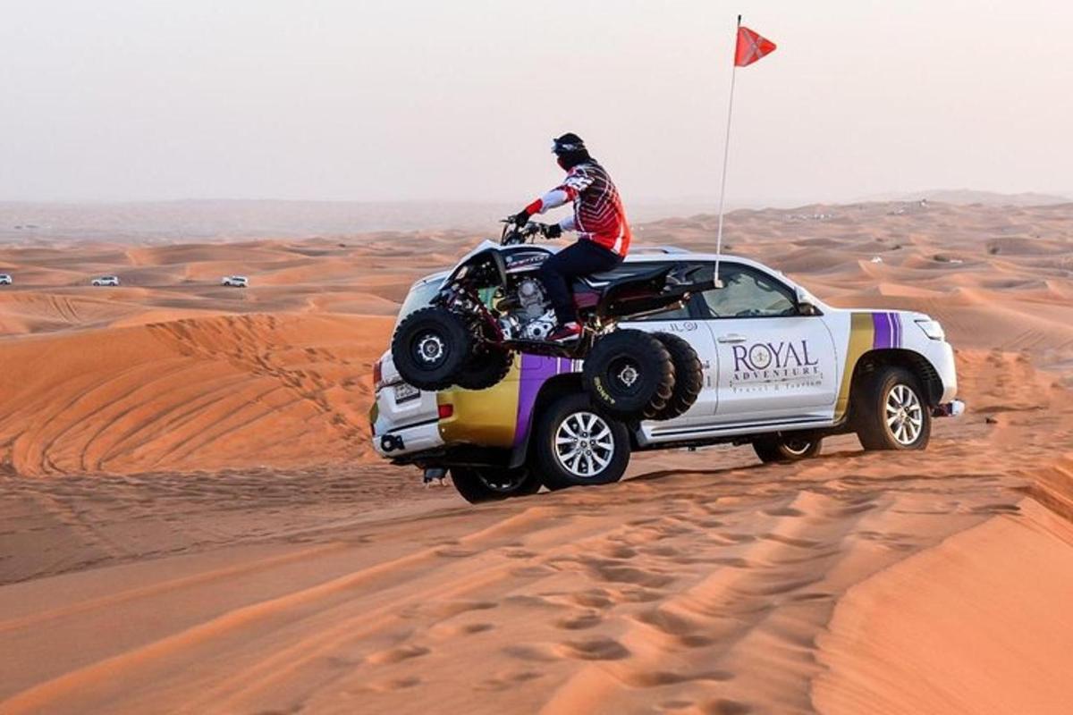 a person riding a quad bike in a truck in the desert