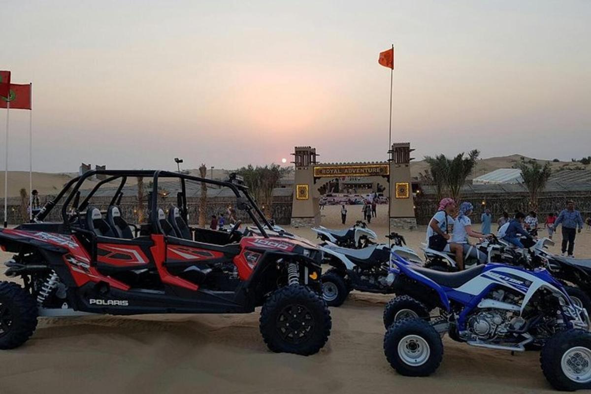 a group of atvs and atvs parked in the sand